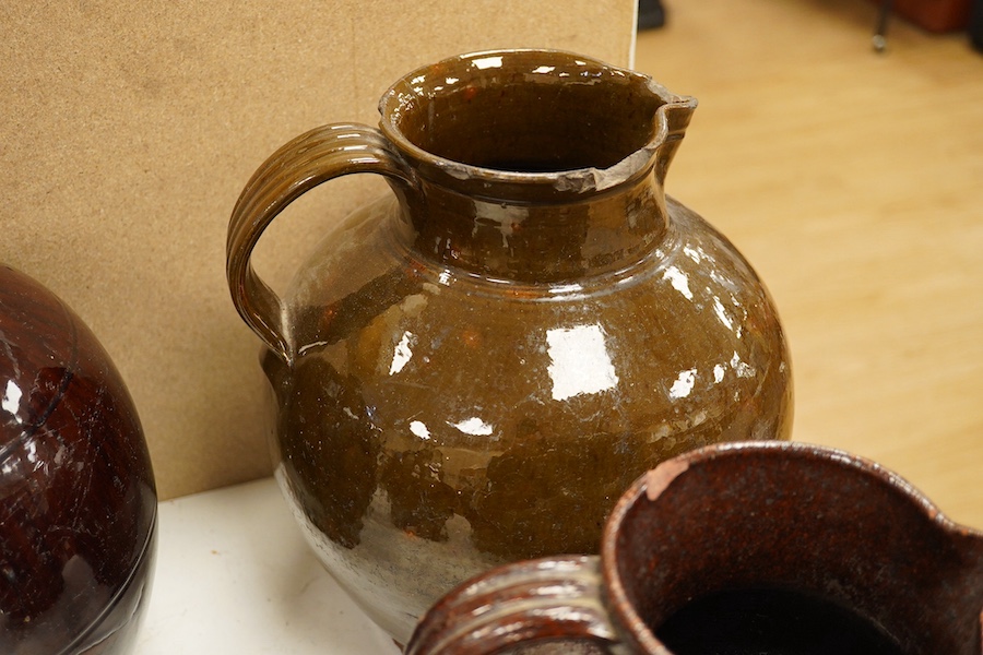 A group of stoneware glazed flagons and jugs, largest 29cm high. Condition - some chips